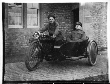 Two soldiers on motorbike with sidecar