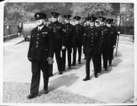 Policemen marching through the street