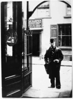 Postman outside Bulmer Rudd's pharmacy